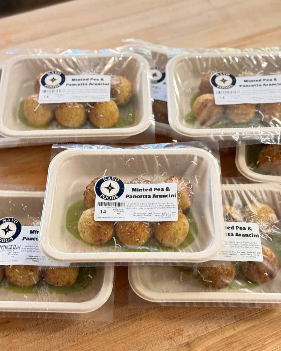 Minted pea and pancetta arancini in Navo-labeled containers